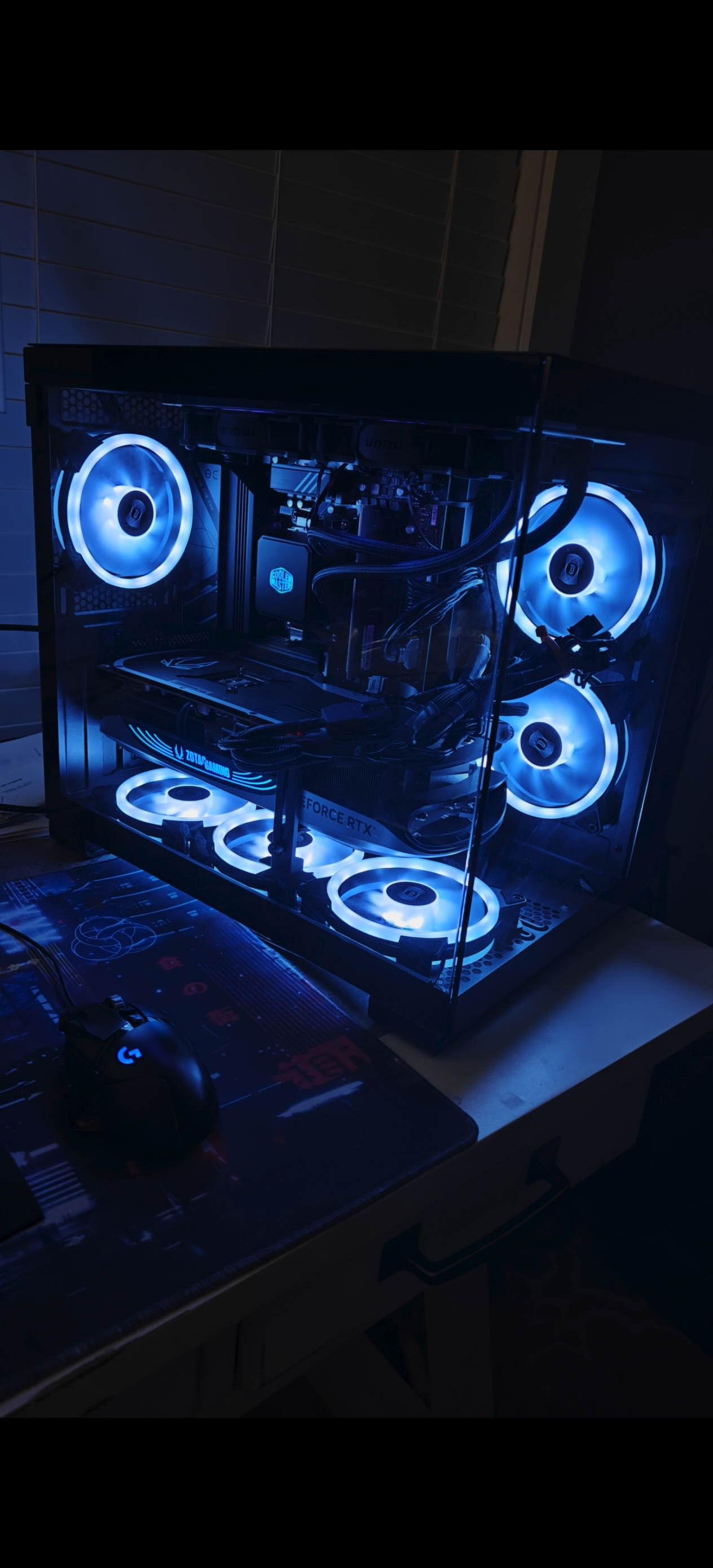 Custom gaming PC build with cyan RGB lighting and RTX graphics card